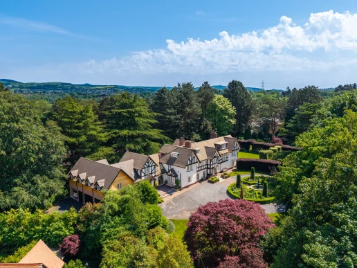 Aerial overview of Fieldhead and its wooded setting at Fieldhead, Prestbury