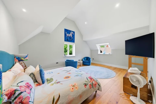 Bedroom beneath a sloping ceiling at Fieldhead, Prestbury