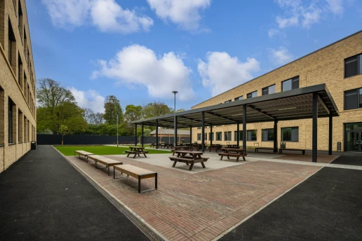 Covered outdoor social space within the school courtyard